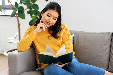 Image showing asian young woman reading book at home