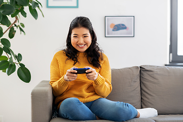 Image showing asian woman with gamepad playing game at home