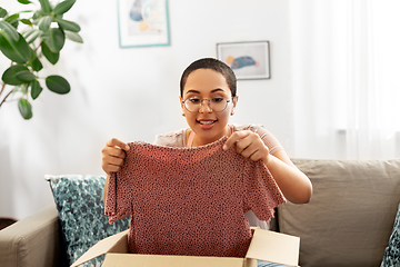 Image showing african american woman opening parcel box at home