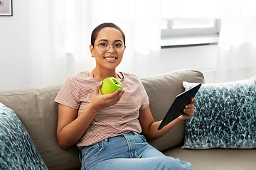 Image showing african woman with tablet pc and apple at home