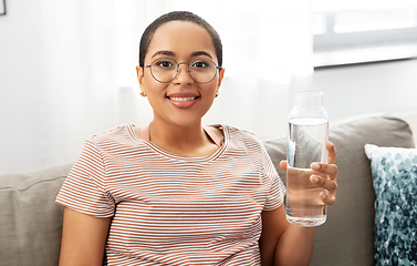 Image showing african american woman with water in glass bottle