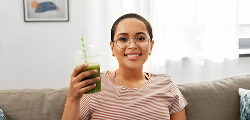 Image showing african american woman drinking smoothie at home