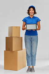 Image showing delivery girl with parcel boxes and tablet pc