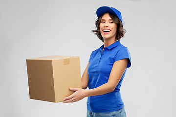 Image showing happy delivery girl with parcel box in blue