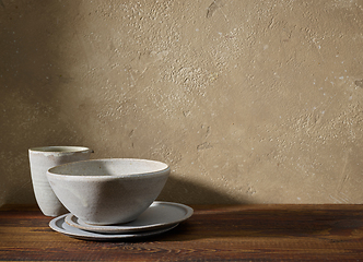 Image showing ceramic tableware on wooden shelf