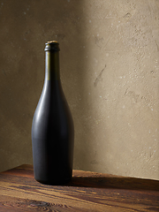 Image showing whine bottle on wooden table