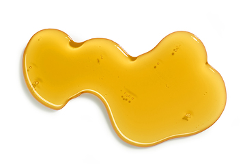 Image showing flowing honey on white background