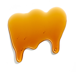 Image showing flowing sugar syrup on white background