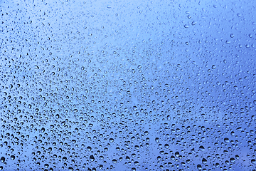 Image showing Water drops on glass, blue natural background