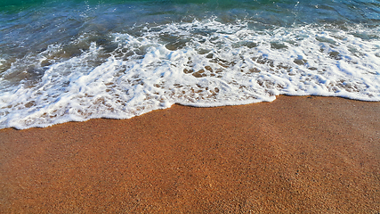 Image showing Sea water with white foam in the coastal sand