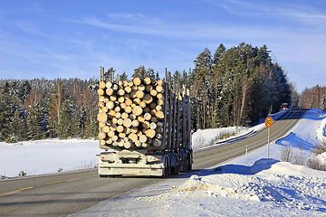 Image showing Logging Truck Transports Load of Logs in Winter