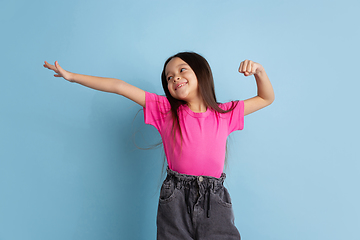 Image showing Caucasian little girl\'s portrait on blue studio background