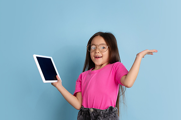 Image showing Caucasian little girl\'s portrait on blue studio background