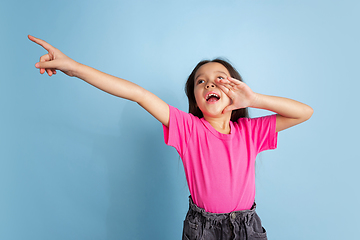 Image showing Caucasian little girl\'s portrait on blue studio background