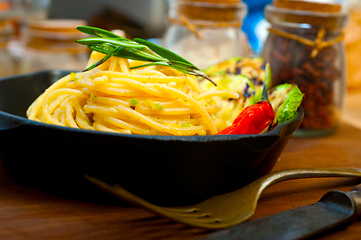 Image showing italian spaghetti pasta with zucchini sauce on iron skillet