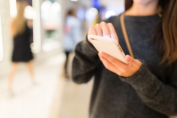 Image showing Woman reading on cellphone