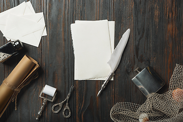 Image showing Old fashioned flat lay with letters writing accessories on dark wooden background