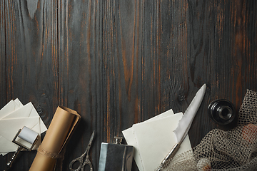 Image showing Old fashioned flat lay with letters writing accessories on dark wooden background