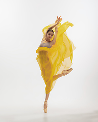 Image showing Young graceful tender ballerina on white studio background