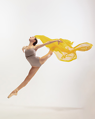 Image showing Young graceful tender ballerina on white studio background