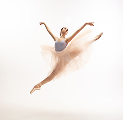 Image showing Young graceful tender ballerina on white studio background