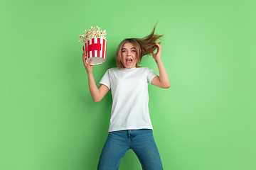 Image showing Caucasian young woman\'s portrait on green studio background