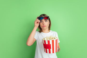 Image showing Caucasian young woman\'s portrait on green studio background