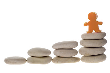 Image showing Figurine on stack of pebbles