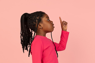 Image showing Handsome african little girl portrait isolated on pink studio background with copyspace