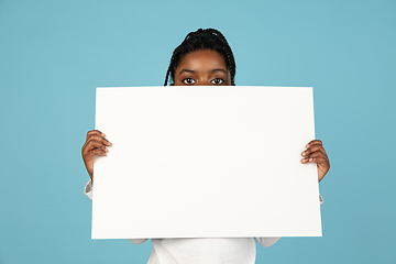 Image showing Handsome african little girl portrait isolated on blue studio background with copyspace