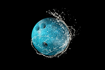 Image showing Bowling ball in water drops and splashes isolated on black background