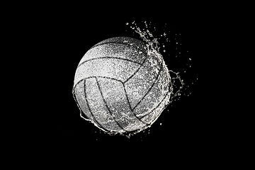 Image showing Volleyball ball flying in water drops and splashes isolated on black background