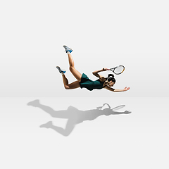 Image showing Young caucasian professional sportswoman levitating, flying while playing tennis isolated on white background