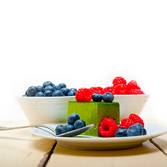 Image showing green tea matcha mousse cake with berries