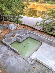 Image showing large luxurious pool under construction by the lake