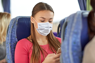 Image showing woman in mask using smartphone in travel bus