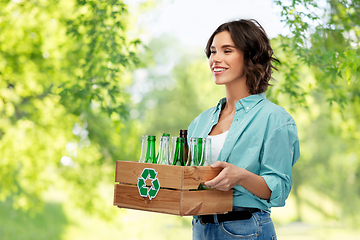 Image showing smiling young woman sorting glass waste