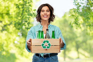 Image showing smiling young woman sorting glass waste