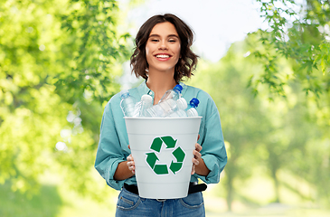 Image showing smiling young woman sorting plastic waste