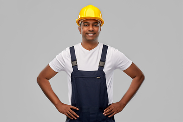 Image showing happy smiling indian worker or builder in helmet