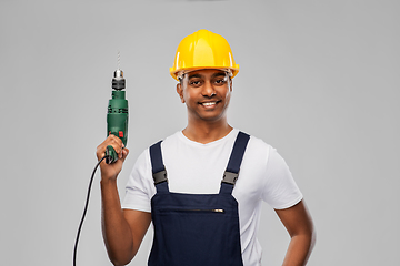 Image showing happy indian builder in helmet with electric drill