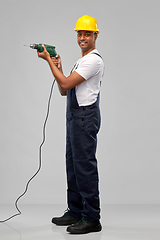 Image showing happy indian builder in helmet with electric drill