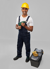 Image showing happy indian builder in helmet with electric drill