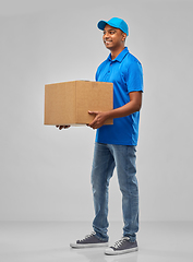 Image showing happy indian delivery man with parcel box in blue