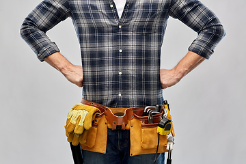 Image showing male worker or builder with working tools on belt