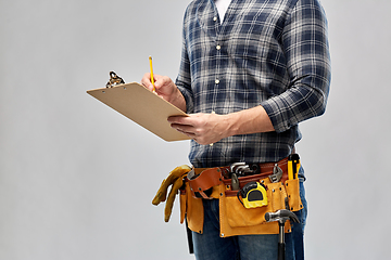 Image showing builder with clipboard, pencil and working tools