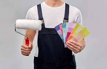 Image showing close up of painter with roller and color charts