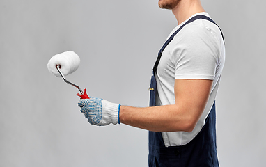 Image showing close up of painter or builder with paint roller