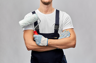 Image showing close up of painter or builder with paint roller