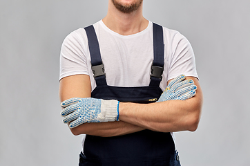 Image showing close up of male builder in overall and gloves